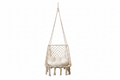 Cream square macrame hanging swing chair with white cushion on white background